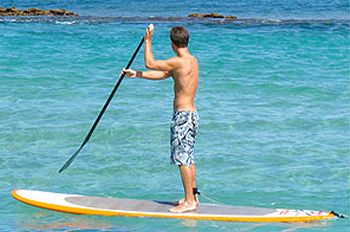 Man on a stand up paddle board in the ocean 