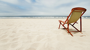 Chair on a white sand beach near the ocean