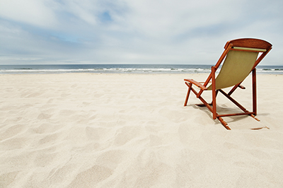 Chair on a white sand beach near the ocean